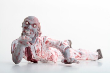 miniature figurine of a zombie doll on a white background