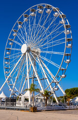Grand Ferris Wheel Grande Roue at Esplanade du Pre des Pecheurs promenade in Vauban Port and yacht marina onshore Antibes resort town harbor in France