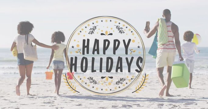 Animation of christmas greetings text over biracial couple with son and daughter on beach