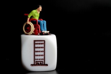miniature figurine of a disabled man on a wheelchair