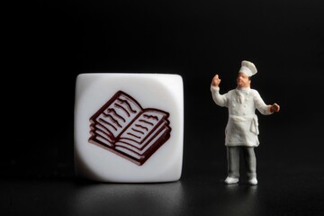 miniature figurine of a chef on a black background with icon