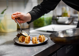 man chef cooking tasty shrimp on kitchen