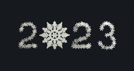 Numbers 2023 made of confetti and snowflake on dark background. Figures of new year.