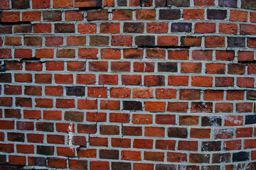 Abstract wall background made of old burnt brick.
