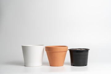 Various pot comparison in isolated white background. Ceramic, Terracotta and Plastic pots comparison