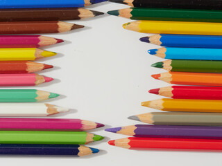 Colored pencils background. Colored pencils on a white background.