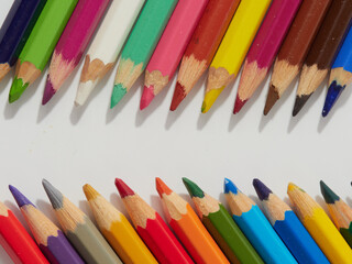 Colored pencils background. Colored pencils on a white background.