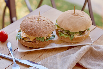 Healthy vegetarian food - burgers with vegetable cutlet, pickled cucumber and greens outdoor