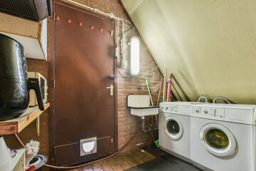 Spacious garage with closed door and garden tools to take care of garden and washing machine