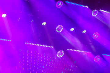 The neon purple light from the spotlights of the cannon beams on the stage is professionally exposed.