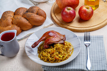 Spelled with duck leg in a plate on the table for Rosh Hashanah next to pomegranate honey apples...