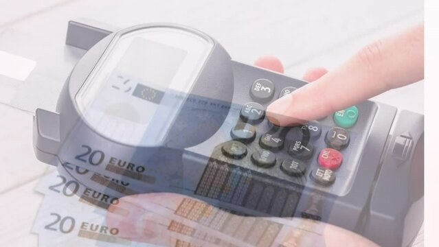 Animation of close up of euro bills flying over mid section of man using card machine