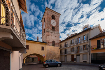 Fototapeta na wymiar Borgo San Dalmazzo, Cuneo, Italy - December 01, 2022: the civic tower, built in the 16th century to allow access to the shelter seen from piazza IV novembre