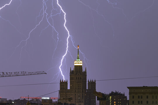 July 10, 2022. Moscow Russia. Lightning in the night sky during a thunderstorm in the Russian capital. In the background is the Stalinist high-rise on the Kotelnicheskaya embankment.