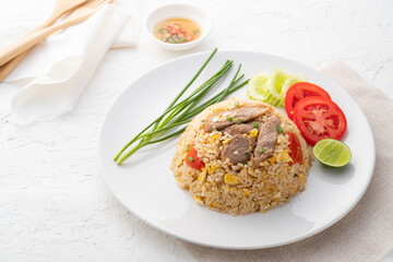 Easy Pork Fried Rice with egg and tomato in white plate.asian food