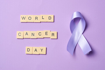 World cancer day banner, february 4th, on flat lay purple.
