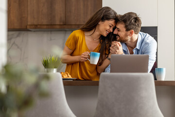 Couple using laptop at home