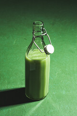 Green smoothie in glass bootle 