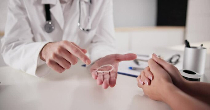 Gynecologist Showing Contraception Ring To Woman