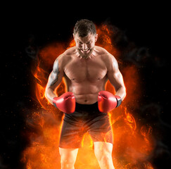 Man boxer in red gloves on fire background