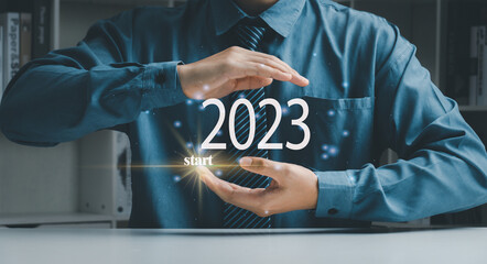 2023 new year goals, actions, plans, ideas, inspiration concept of Businessman with sparkling light effect on palm of hand with target sign. Start 2023, 2023 concept.