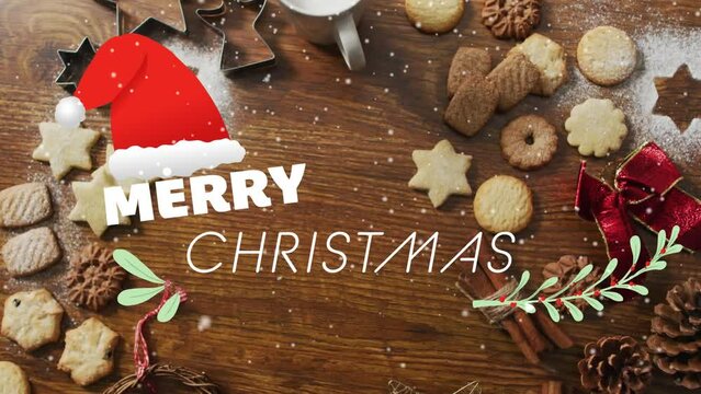Animation of merry christmas text over christmas cookies and decorations on wooden background
