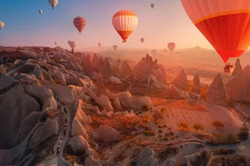 Poster Tour excursion on horse autumn landscape with hot air balloons in Cappadocia Turkey top aerial view © Parilov