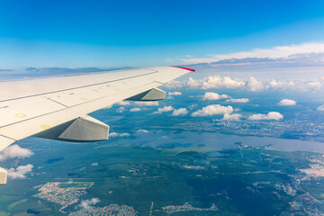 Obraz premium View from the airplane window during taking off on a clear summer morning. Yekaterinburg, Russia