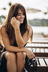 Portrait of beautiful woman in black dress in summer days