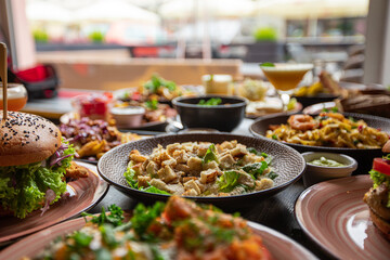 Light palatable food on wooden table in restaurant or cafe against window. Celebration, traditional party for holidays