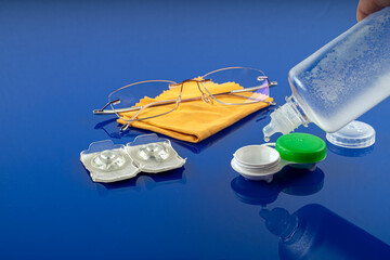 Contact lens kit with bottle of lens solution, case, glasses ,top view.