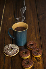 Chocolate donuts and coffee , weekend morning table breakfast