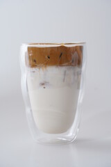 pouring coffee cream in to glass of ice milk