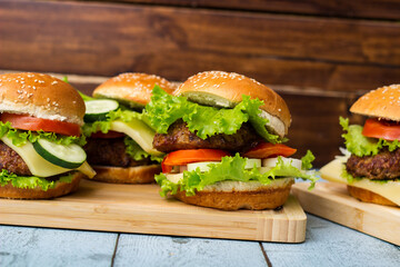 Fresh grilled burgers served on wood table
