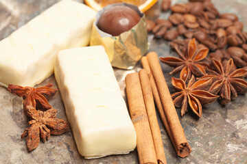 White chocolate candies with anise,cinnamon sticks,coffee beans.