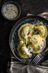 Mezzelune filled with parmesan and asparagus with creamy sauce.