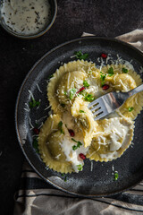 Mezzelune filled with parmesan and asparagus with creamy sauce.