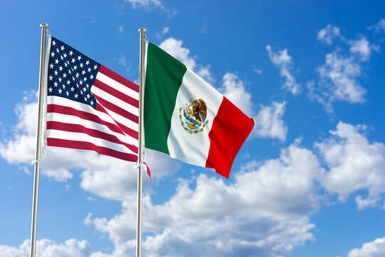 United States of America and Mexico flags over blue sky background. 3D illustration