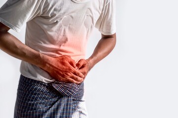 Asian man suffering from upper abdominal pain. It can be caused by stomach ache, enteritis,...
