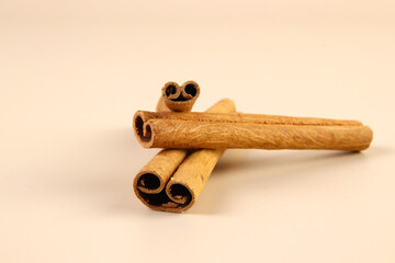 Cinnamon sticks on beige background