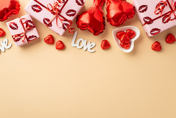 Valentine's Day concept. Top view photo of gift boxes in wrapping with kiss lips pattern heart shaped balloons plate candies and inscription love on isolated pastel beige background with copyspace