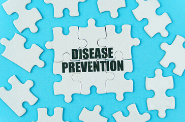 On a blue background are white puzzles with the inscription - DISEASE PREVENTION