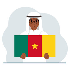A man holds the flag of Cameroon in his hands. The concept of demonstration, national holiday or patriotism. Nationality.