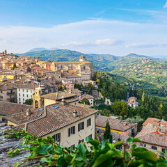 Fototapeta premium View from above of the Italian city: you can see the roofs of houses, in the distance - the mountains.