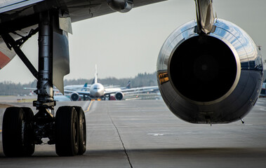 Jet engine under the wing of a modern passenger aircraft at an international airport