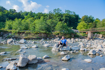 river bridge stones grey muccina in blue by the water