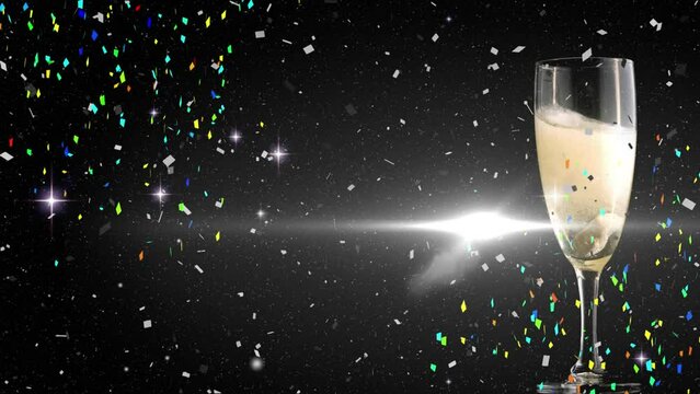 Animation of stars and confetti over glass of champagne