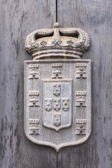 Ancient Portuguese coat of arms with crown, towers and shields