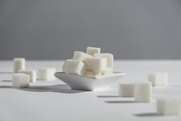 Natural sweetener in a wooden spoon. Sugar substitute. Erythritol. High quality photo. Photo of sugar on a white background, with copy space