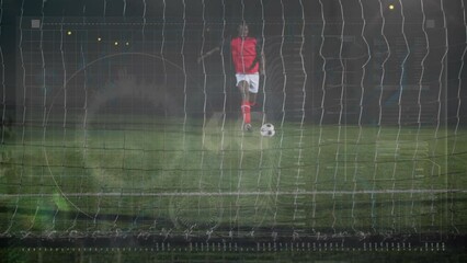 Animation of data processing over african american male soccer player taking a penalty kick - Powered by Adobe
